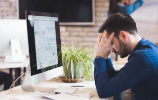 Worried Employee at Computer Facing the Pressure and Stress of an Upcoming Deadline